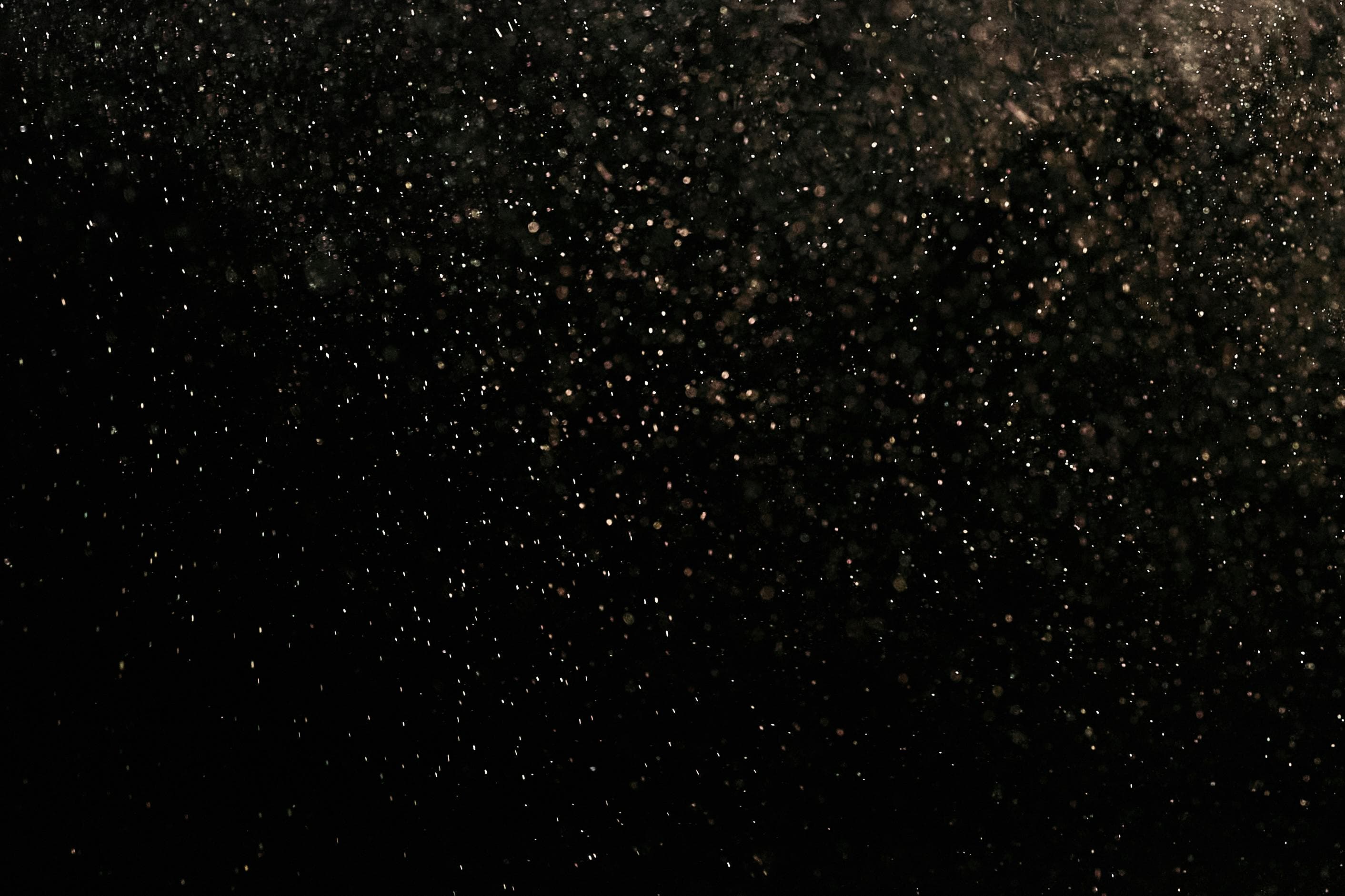 gold sparkles on a black bg